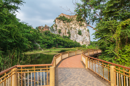 Bridge walkway along the water, forest and mountains.の写真素材