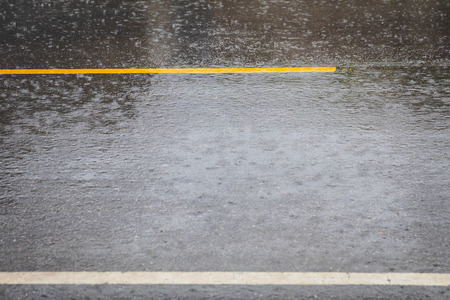 Rain makes the road slippery roads.の写真素材