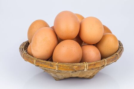 Eggs in the basket on white background.の写真素材