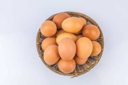 Eggs in the basket on white background.の写真素材