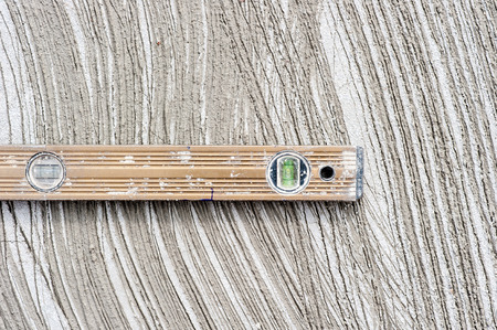 The bubble level on cement background.の写真素材