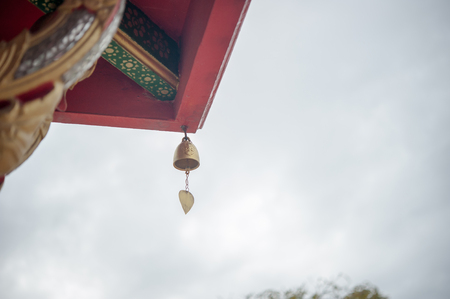 Small gold color of buddhist bell in the templeの写真素材