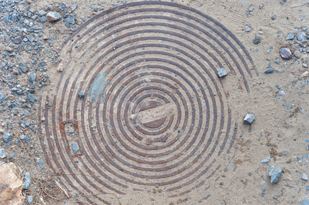 Old circle rusty iron manhole coverの写真素材