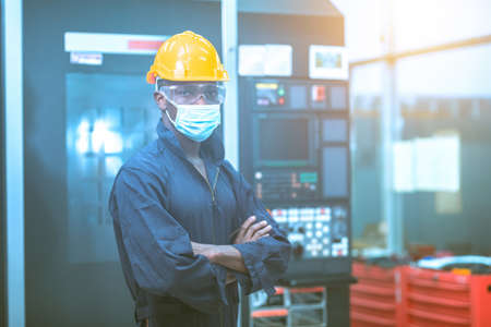 The engineer in the industrial working with computer control the machineの写真素材