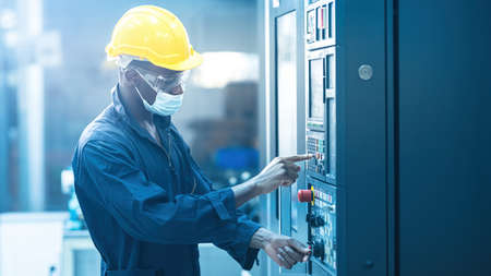 The egineer in the industial working with laptop computer control the machineの写真素材