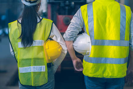 The white safety helmet engineer use tablet for a lathe for shaping the steel for a part follow blueprint in the tablet machinery in the factory industrialの写真素材