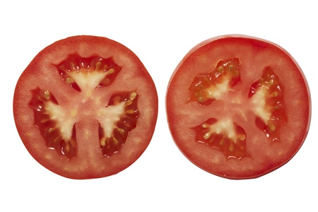 Two pieces of slide tomatoes on white の写真素材