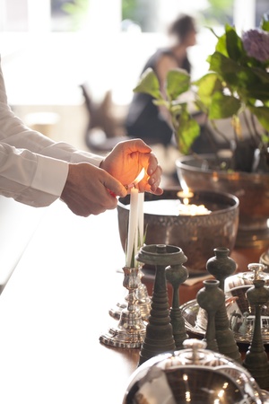 Hands lighting candle in partyの写真素材