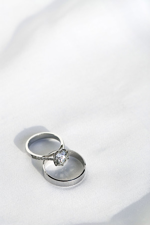 Two wedding ring on white fabric backgroundの写真素材