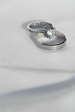 Two wedding ring on white fabric backgroundの写真素材