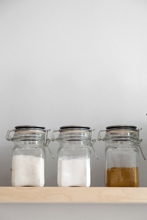 Salt,flour and brown sugar in storage on shelfの写真素材