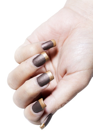 Hand with brown and gold color nail varnishの写真素材