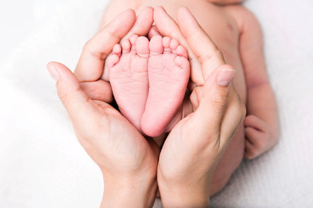 Hand holding baby feet