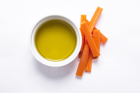 Cut carrot and olive oil on backgroundの写真素材