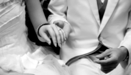 Hand of Groom holding his bride