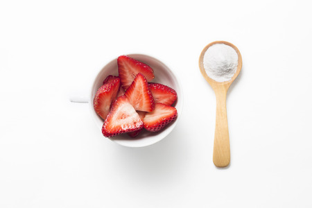 Strawberries and baking soda in wooden spoon for tooth whiteningの写真素材