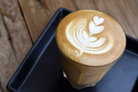 Coffee with heart shape latte art serve in glassの写真素材