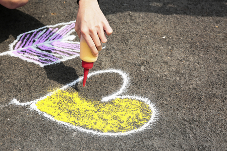 Hand painting sand on ground in heart shapeの写真素材