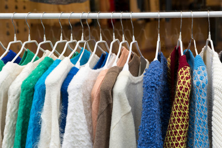 Colourful sweaters on clothes rackの写真素材
