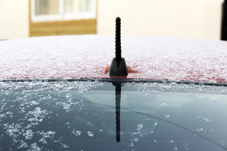 Snow on red color car roofの写真素材
