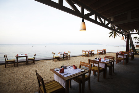 Empty dinner tables on sea coastの写真素材
