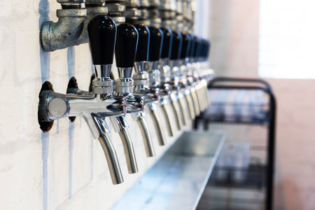 Row of metal spigots for drink testingの写真素材