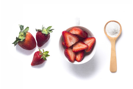 Strawberries and baking soda in wooden spoon for tooth whiteningの写真素材