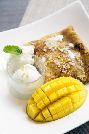 Delicious mango crepe with coconut ice-creamの写真素材