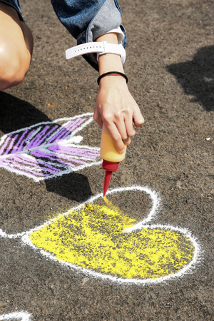 Hand painting sand on ground in heart shapeの写真素材