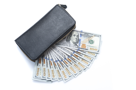 Hundred dollar bills stacked in handbag on backgroundの写真素材