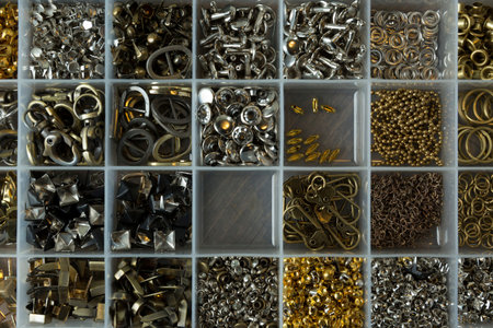 Pins, buttons, and accessories for leather work in box