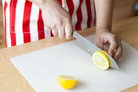 Hand using knife for cut and slide lemonの写真素材