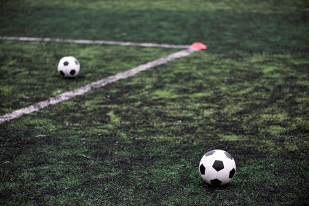 Training Balls in green soccer field