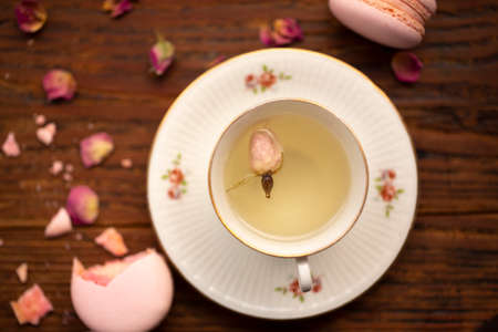 Cup of pink rose tea top view on tableの写真素材