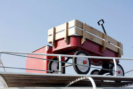 Vintage red carriage for kid on car rooftopの写真素材