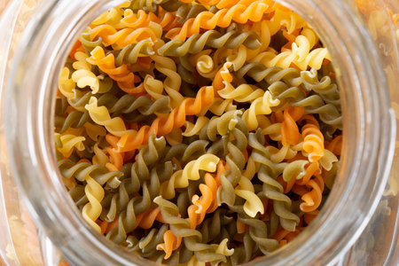 Colorful dried macaroni in storage