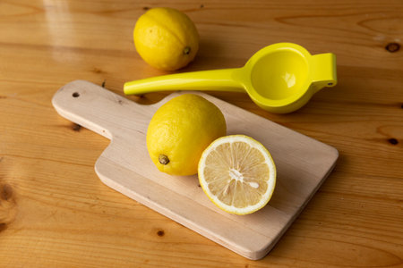 Lemon for making juice on wooden plate