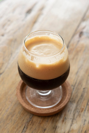 Nitro cold brew coffee on wooden table