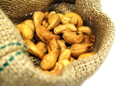 Cashew nut in à¸ºBrown Sack isolated white backgroundの写真素材