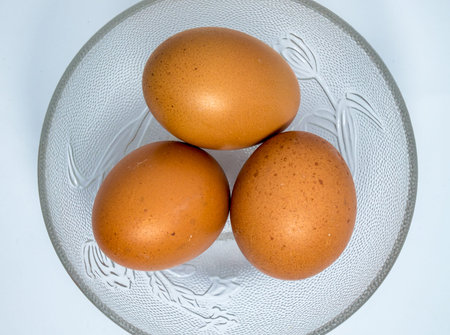 Eggs in a bowl on a white background.