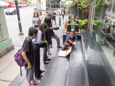 Silom BANGKOK,THAILAND-16 AUGUST 2018:  In the morning, people are walking to work and doing...