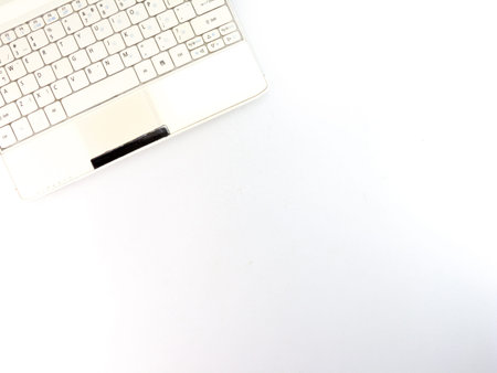 Top view of white laptop closeup on white background.の写真素材