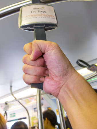 On the BTS BANGKOK,THAILAND-18 AUGUST 2018: The man caught the rail on the train. on, 18 AUGUST 2018, in Thailand.のeditorial素材