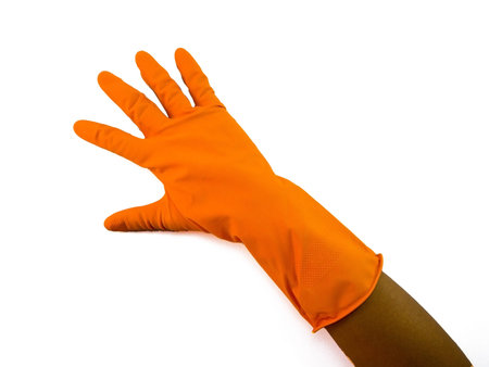 Hand with orange cleaning gloves showing symbolic gestures.の写真素材