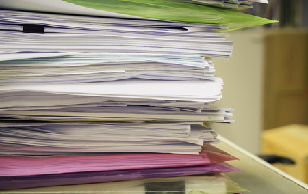 Pile of papers on the deskの写真素材
