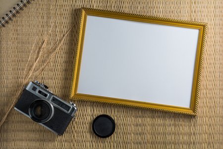 Notebook white on a wooden floor with a film camera.の写真素材