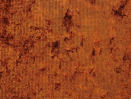 Dust on the metal mesh and the orange backgroundの写真素材