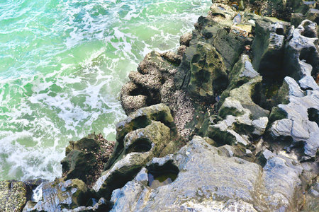 Hole on the stone surface by the sea at Thailand