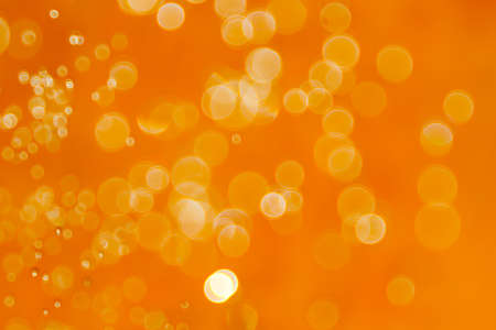 Blurred images and bokeh made from water droplets in orange tonesの写真素材
