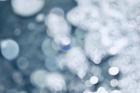 Blurred images and bokeh made from water droplets in cool tonesの写真素材